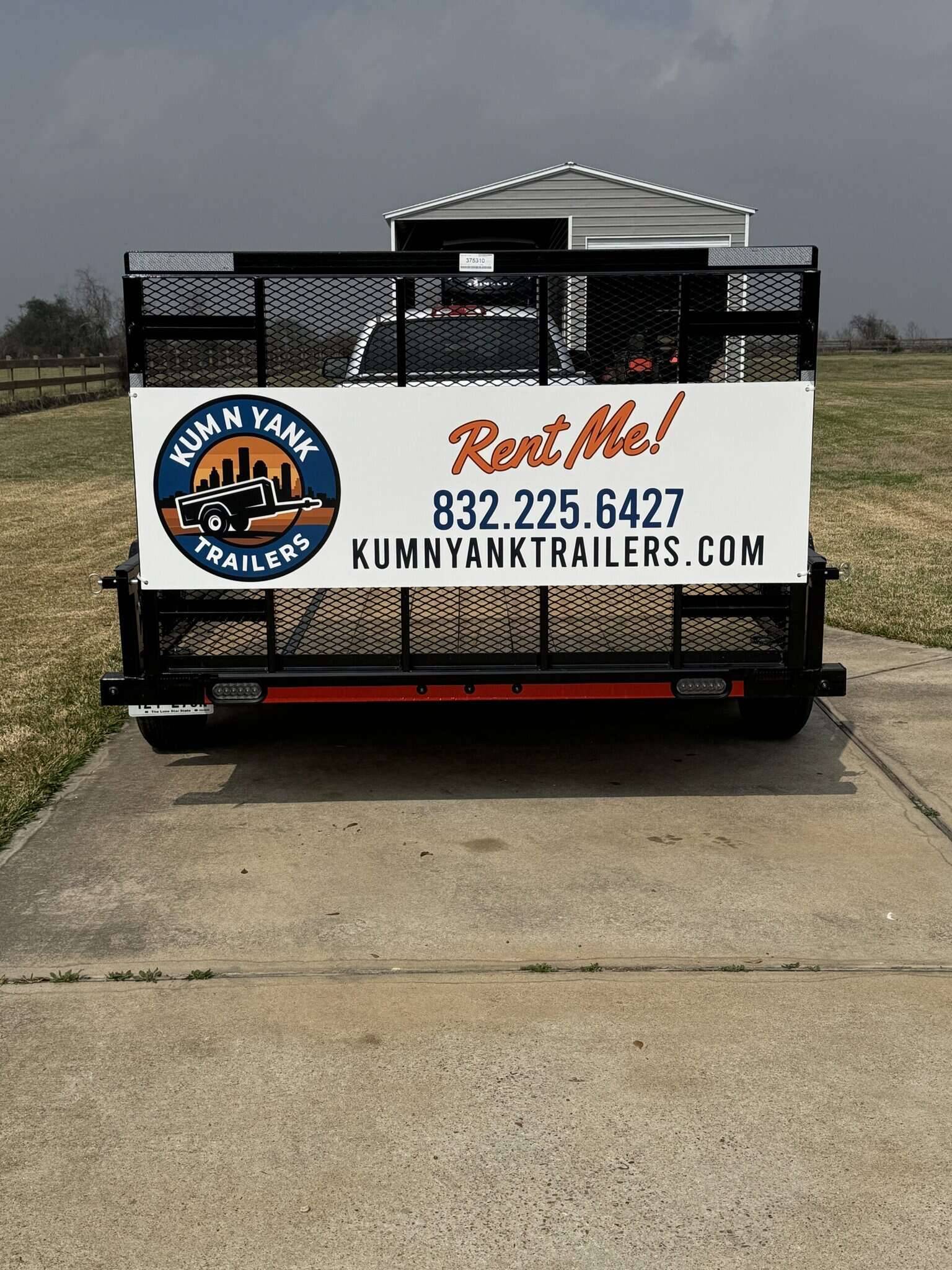 Trailer with Kum N Yank Trailers logo and contact info.