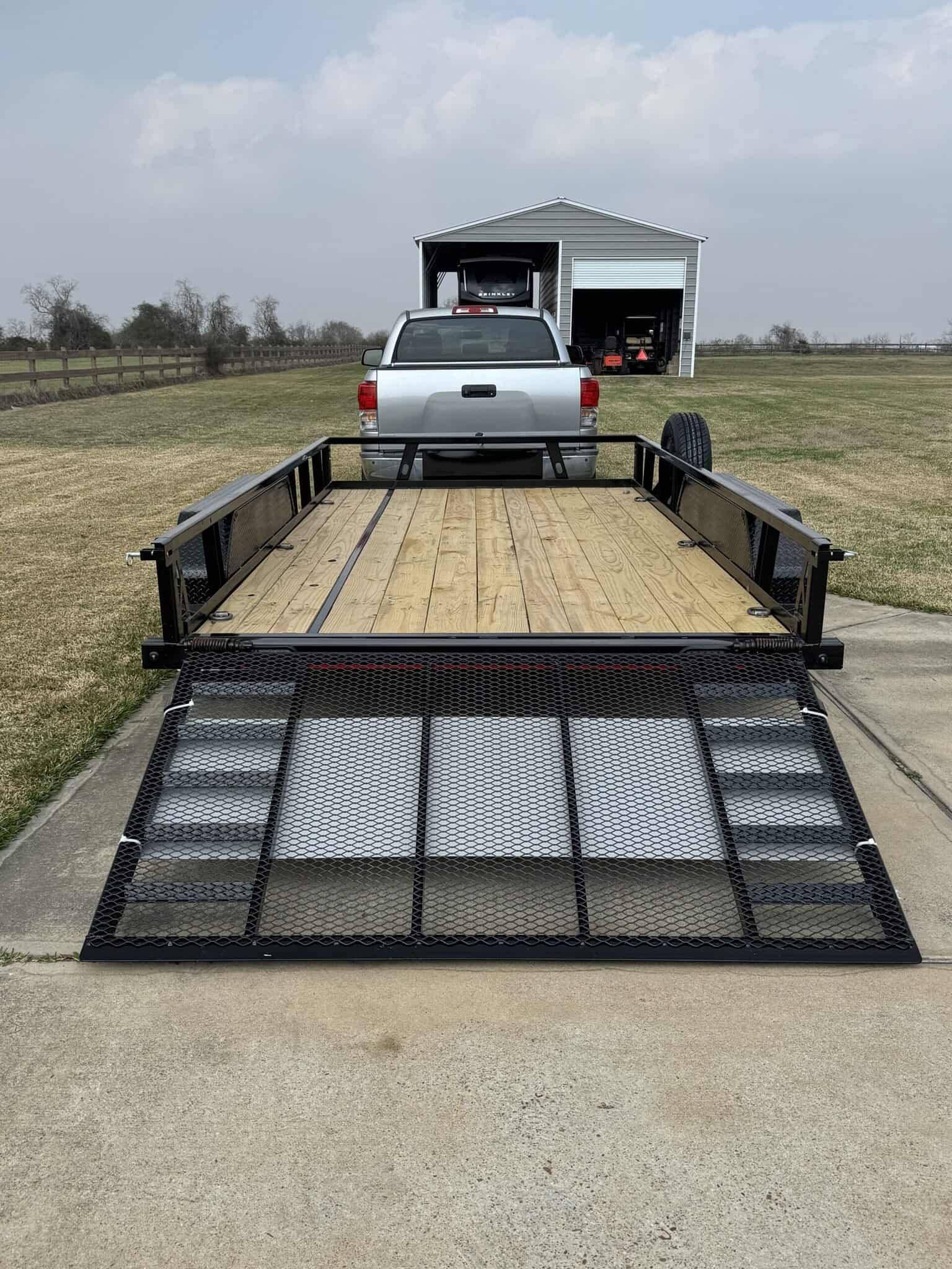 Utility trailer with ramp for transporting equipment and vehicles.