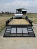 Heavy-duty utility trailer with ramp for hauling equipment and vehicles.